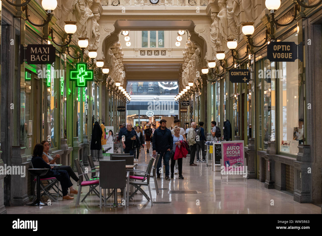 Shopping gallery in central Brussels, Belgium, with visitors browsing shops and cafes Stock Photo