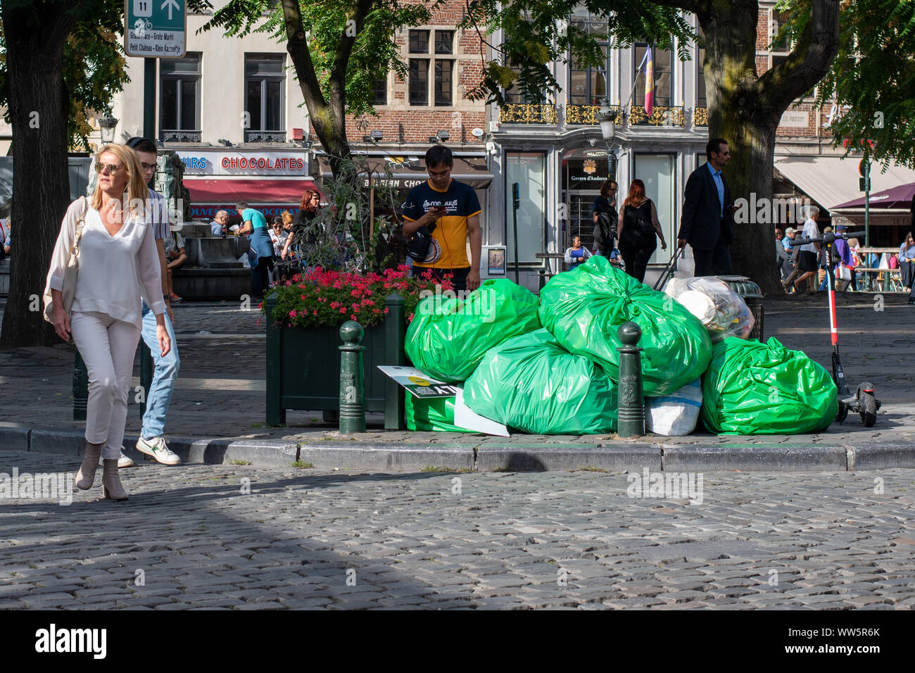 A pile of garbage bags of domestic and commercial waste on a central square in Brussels, as passers-by look away Stock Photo