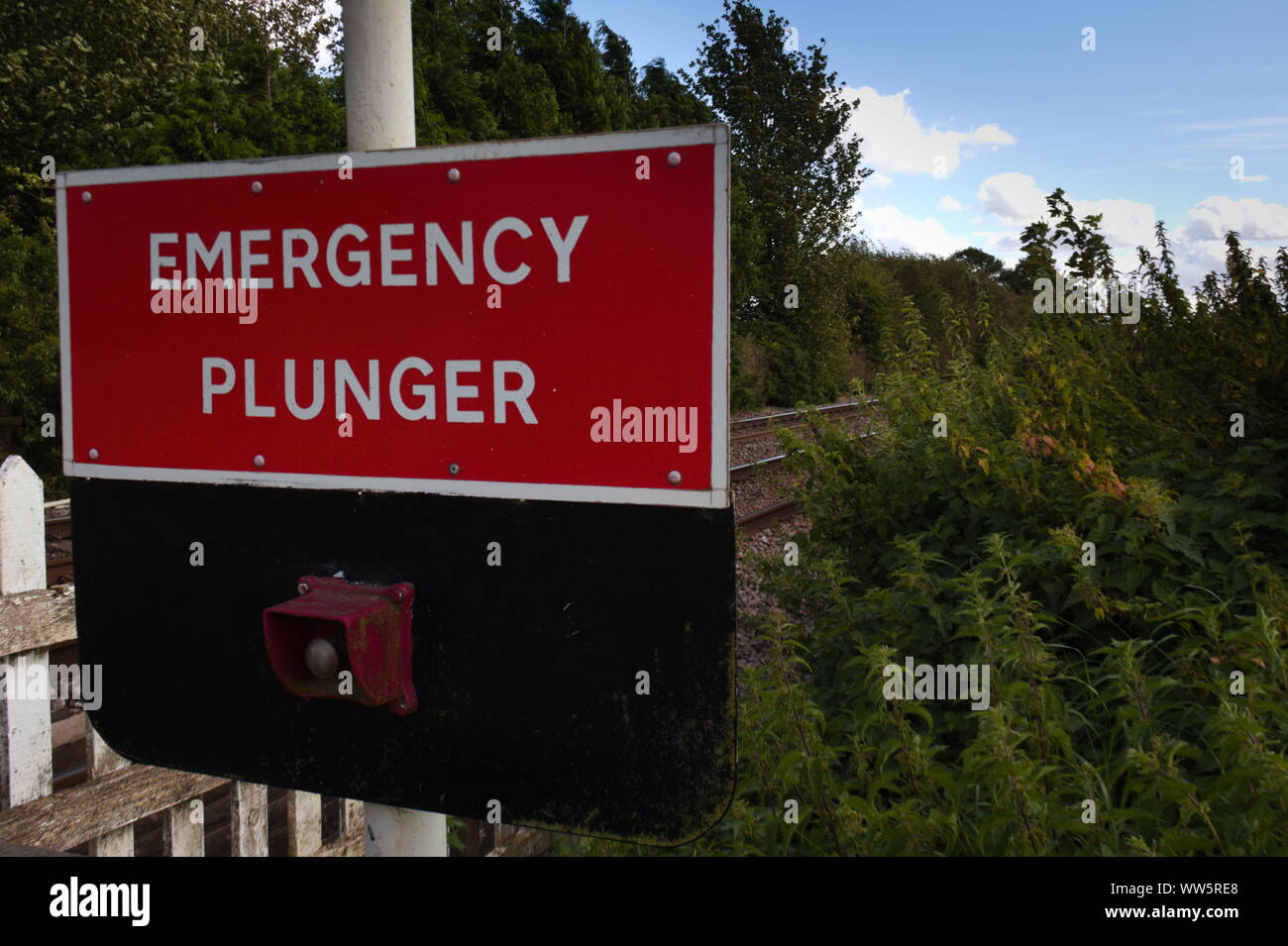Emergency plunger sign on a rural rail crossing Stock Photo