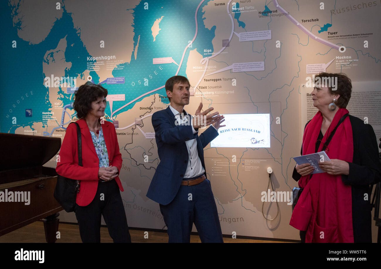 13 September 2019, Saxony, Leipzig: Eva-Maria Stange (SPD, l.), Minister for Science and Art in Saxony, is guided by Gregor Nowak, Managing Director of the Schumann-Verein Leipzig, and Beatrix Borchard, Curator, through the new exhibition of the Schumann-Haus in Leipzig. 200 years after her birth, the city of Leipzig honours the pianist Clara Schumann with a new permanent exhibition. The show illuminates the marriage with the composer Robert Schumann and can be seen in the first joint apartment of the two. It shows the different working and living conditions of the artists. Photo: Hendrik Schm Stock Photo
