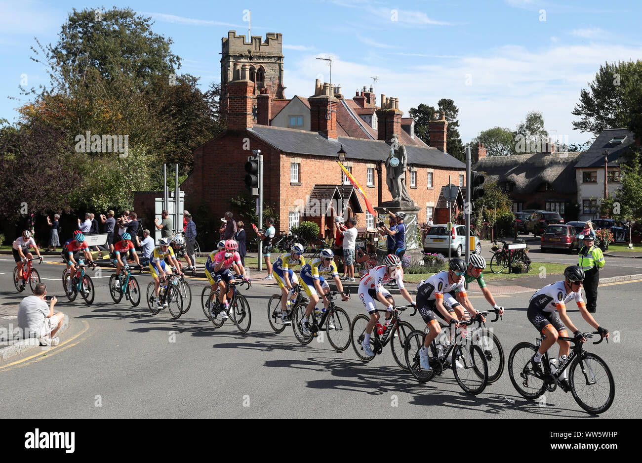 The peloton rides through Dunchurch during stage seven of the OVO Energy Tour of Britain from Warwick to Burton Dassett Country Park. Stock Photo