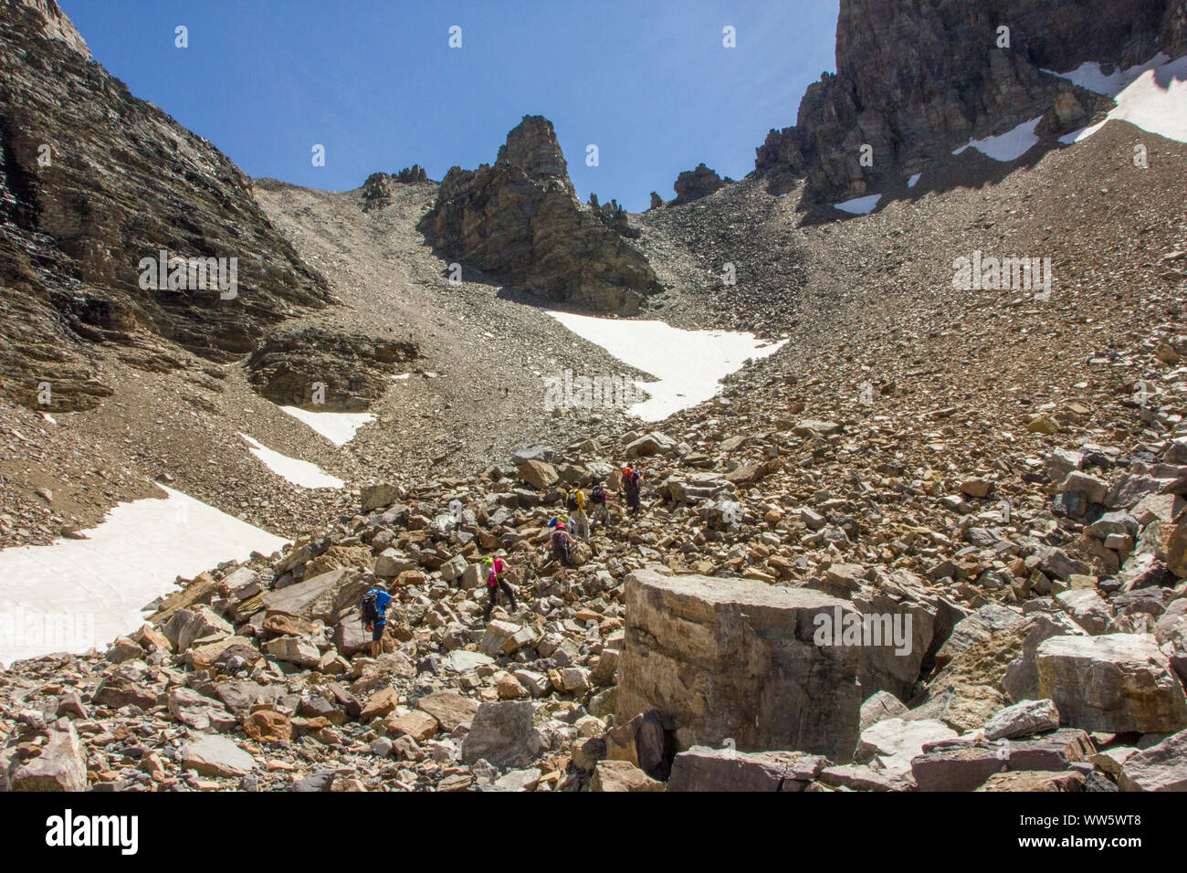 Hiker in a scree field in the Rocky Mountains Stock Photo