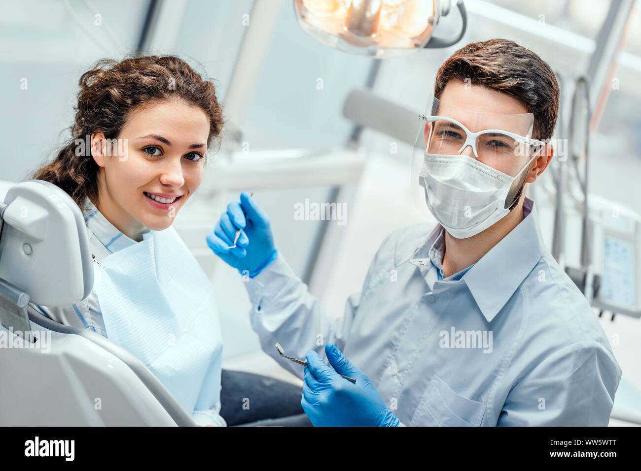 Young woman having check up and dental exam at dentist. Side view. Stock Photo