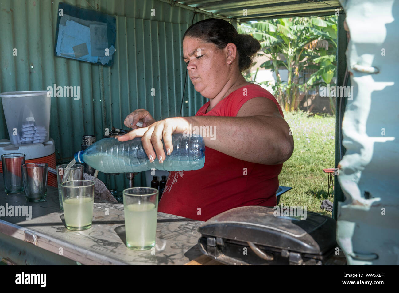 Kiosk with refreshments and snacks on the way to Trinidad, a woman pouring in lemonade Stock Photo