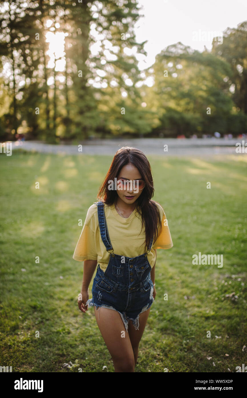Woman walking in public park hi-res stock photography and images - Alamy
