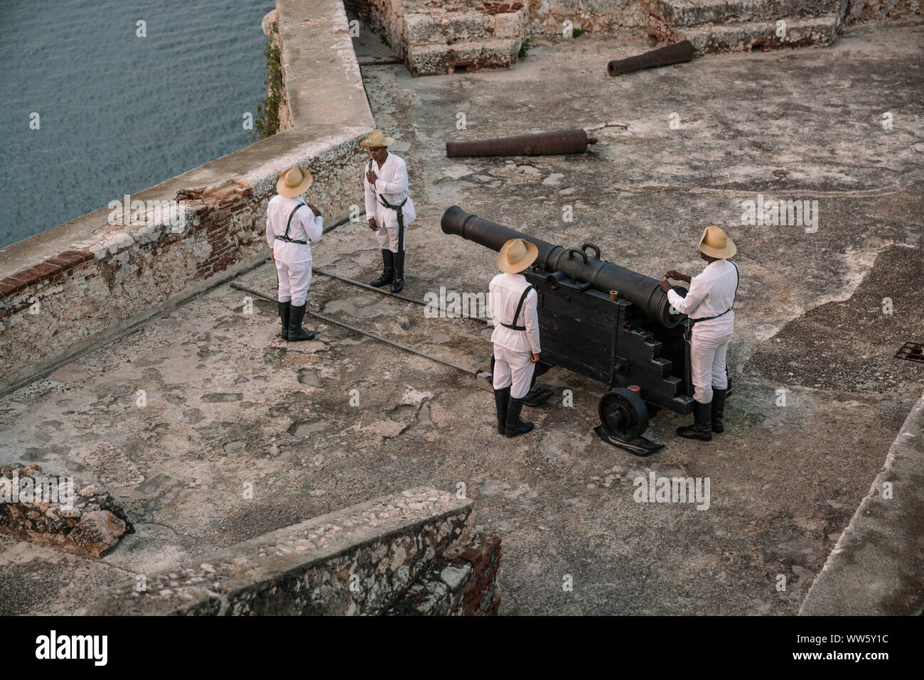 The fortress of Santiago de Cuba, soldiers preparing the cannon shot every evening at sundown, Castillo San Pedro de la Roca, Cuba Stock Photo
