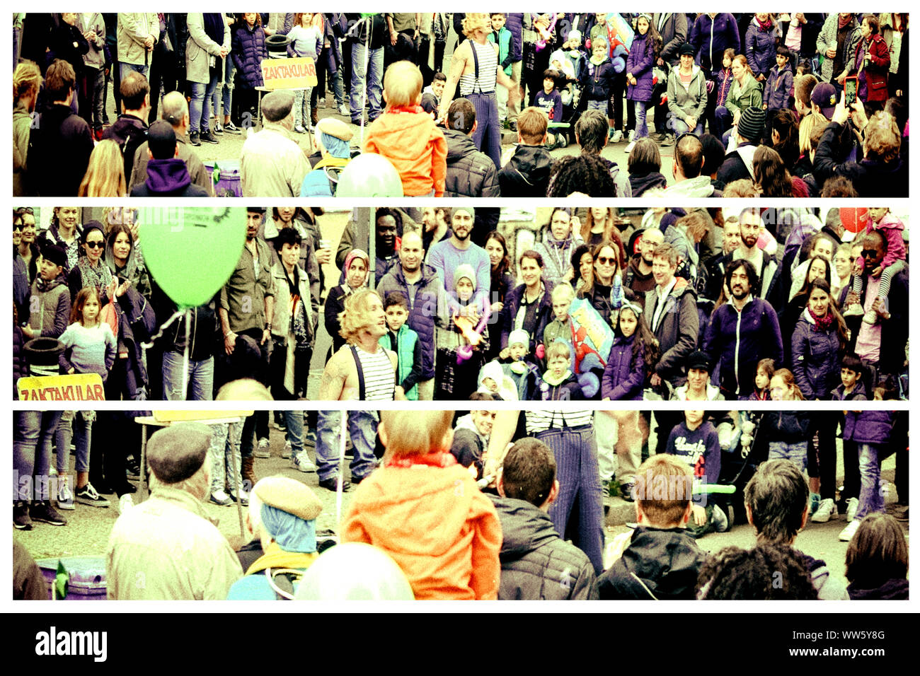 Travelling artists and tourists standing and performing in a street in Kreuzberg at the annual demonstration on the 1st of May, 2017 in Berlin. Stock Photo