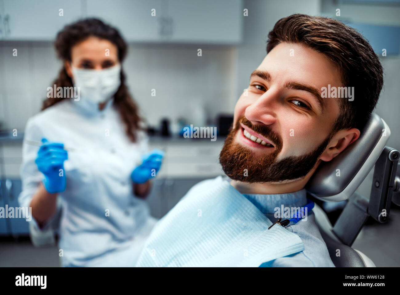 Portrait of happy patient in dental chair. Stock Photo