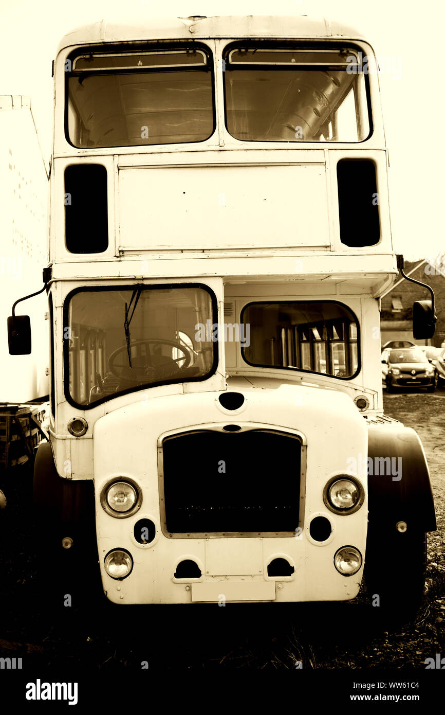 The side view of an old discarded double-decker bus on a scrap yard, Stock Photo