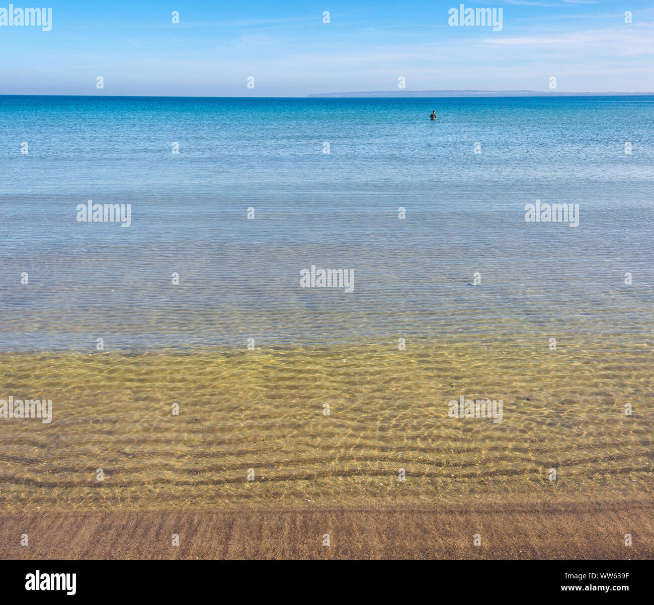 Lonesome angler in the sea Stock Photo