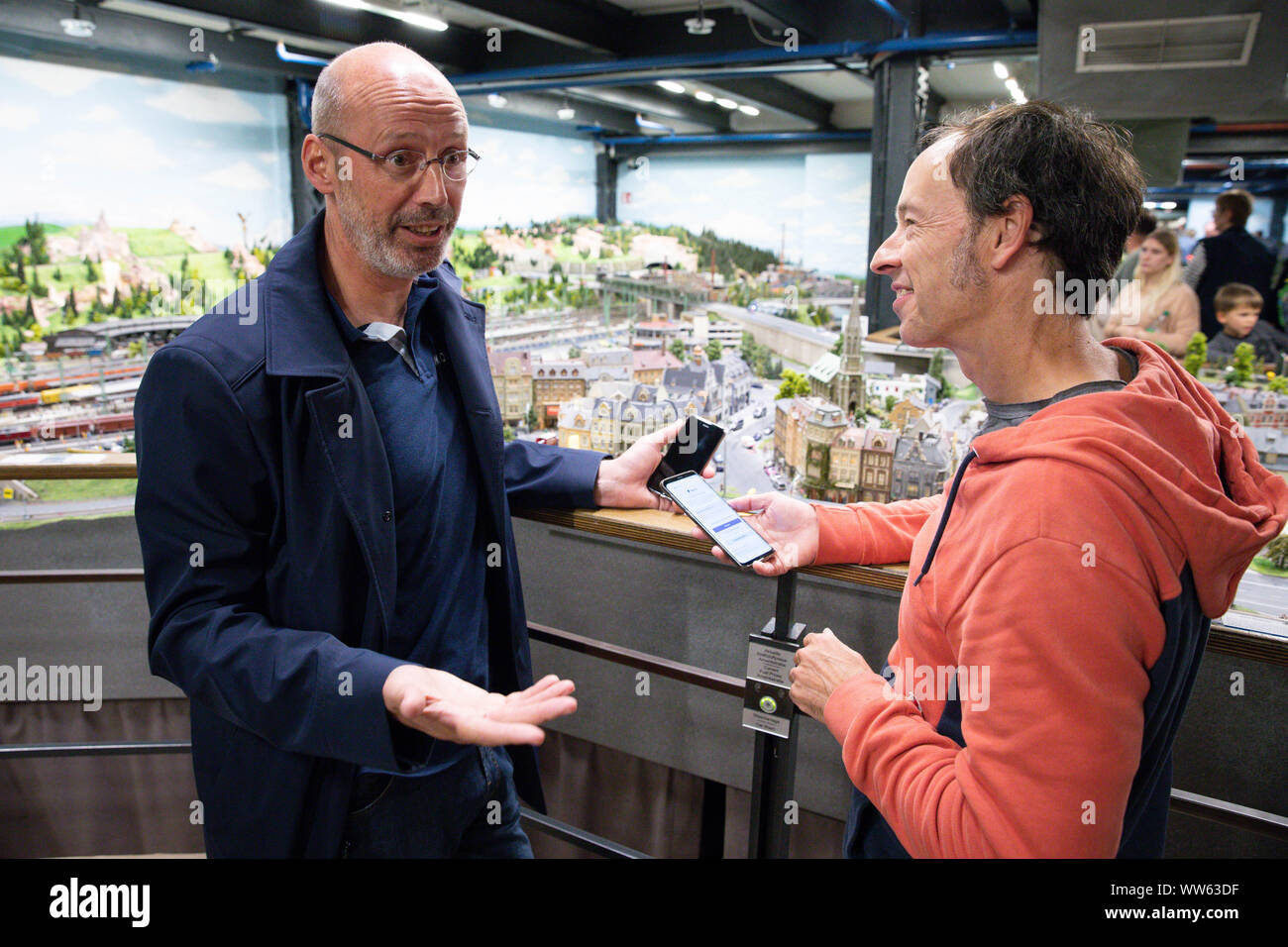 Hamburg, Germany. 13th Sep, 2019. Jens-Michael May (l), Managing Director of Moia Operations Germany GmbH, and Gerrit Braun, one of the founders and Managing Directors of Miniatur Wunderland, talk about the presentation of a Moia model car in the streets of Knuffingen in Miniatur Wunderland. On Friday, the vehicle was inaugurated in Miniatur Wunderland at a press event. Credit: Christian Charisius/dpa/Alamy Live News Stock Photo