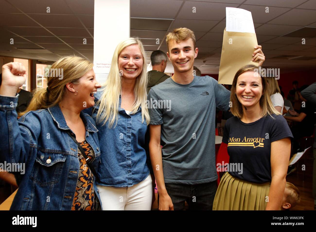 Alex Veal, who achieved six 9 grades, is congratulated by teaching staff Anna Grogan, Alice O'Riordan and Nicola Lambert-Masters, at GCSE results day Stock Photo