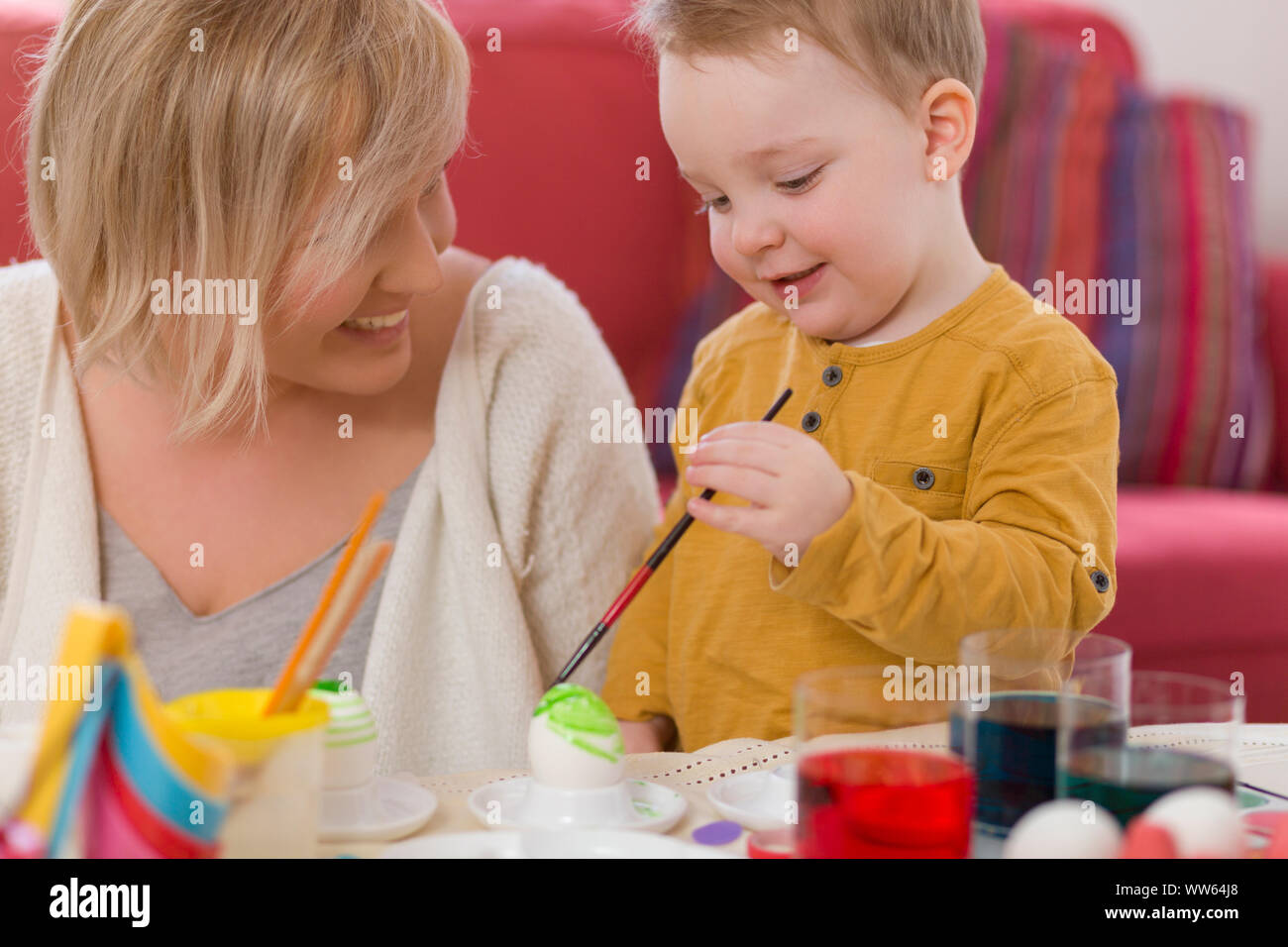 Mother, toddler, Painting Easter eggs, happy Stock Photo
