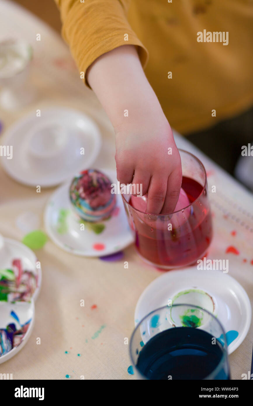 Child, dyeing Easter egg, dipping, colourful hands Stock Photo Alamy