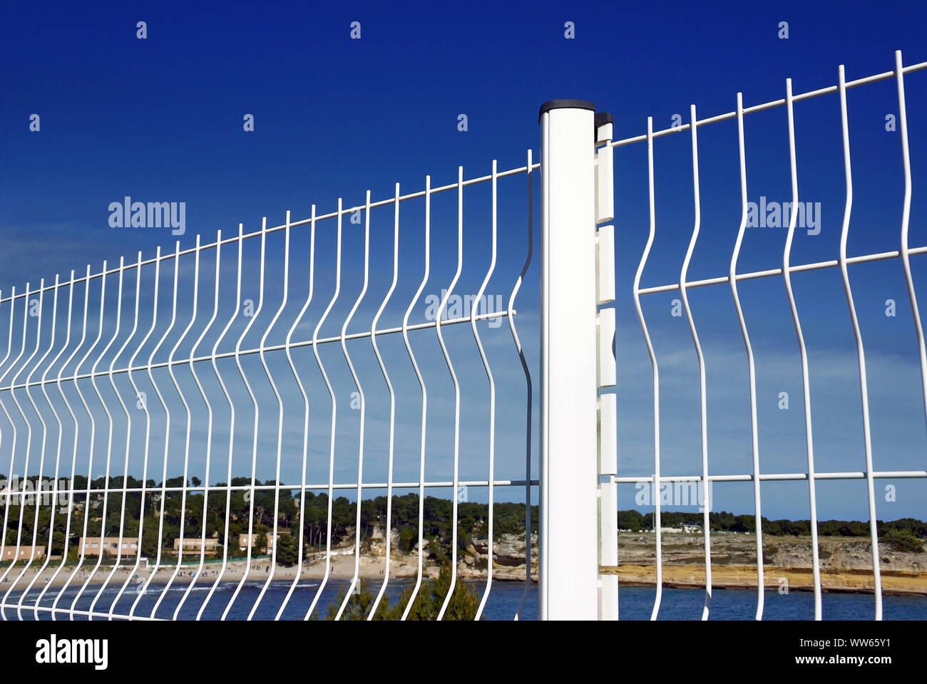 White metal fence on blue sky Stock Photo Alamy