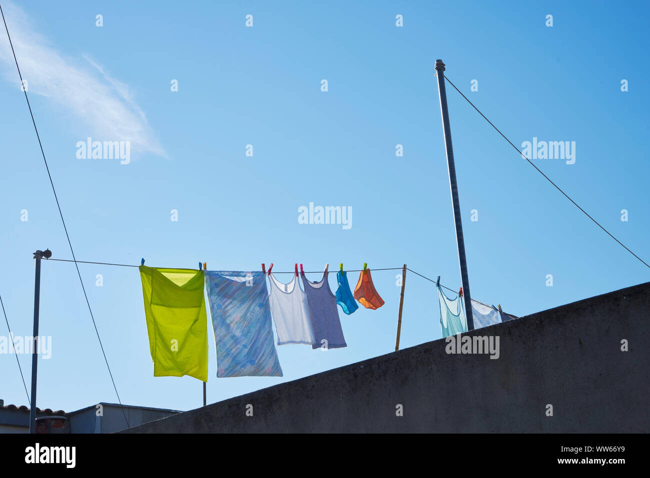 Roof of a house with clothesline and laundry hanging up to dry Stock Photo