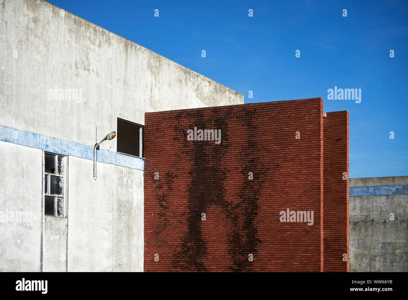 Old warehouse with red brick wall in front of blue sky Stock Photo