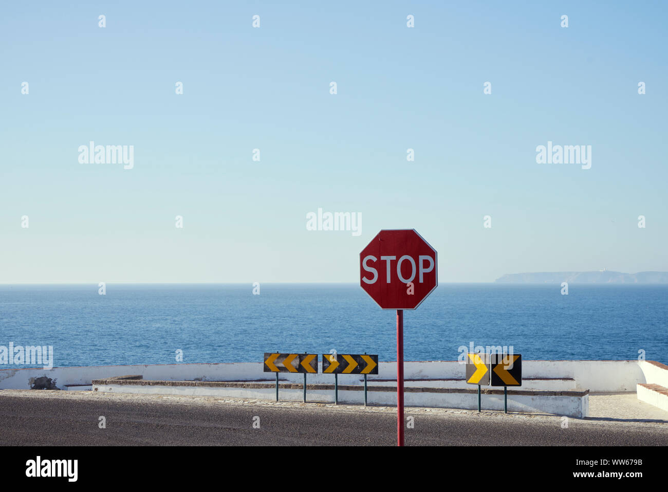 Stop sign on a street by the sea Stock Photo