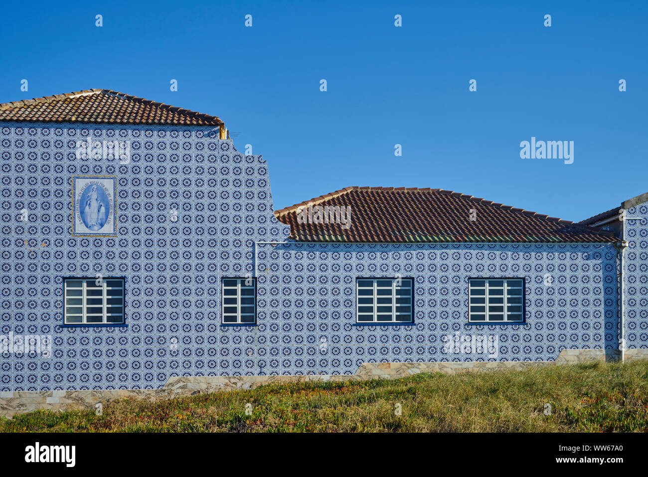 Monastery with white blue tiles in front of blue sky Stock Photo