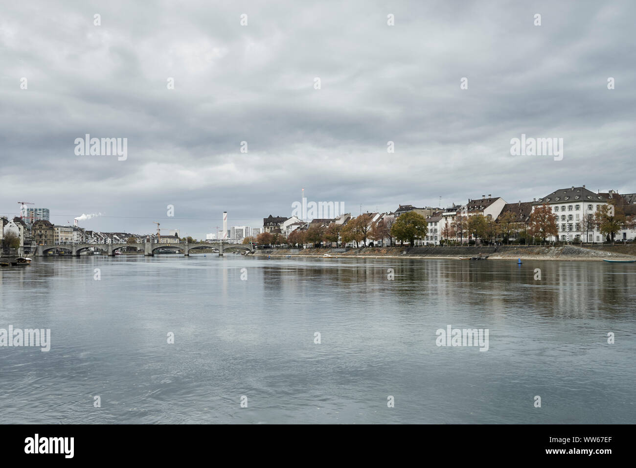 The Rhine in Basel with shore and row of houses at the waterfront Stock Photo