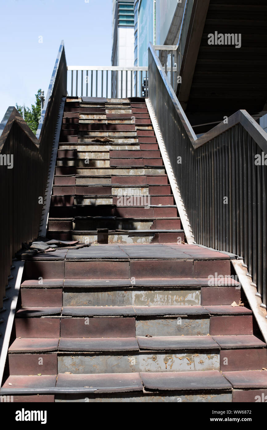 Damaged staircase. Old staircase in the metropolis. Broken stairs on a