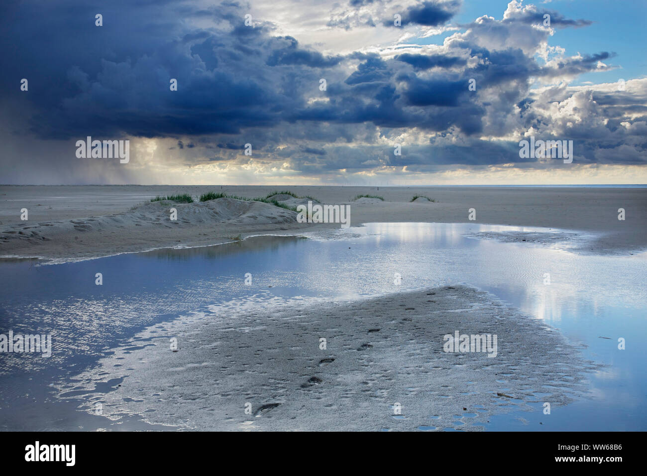 Shower above the Bill-Riff of the island Juist. Stock Photo