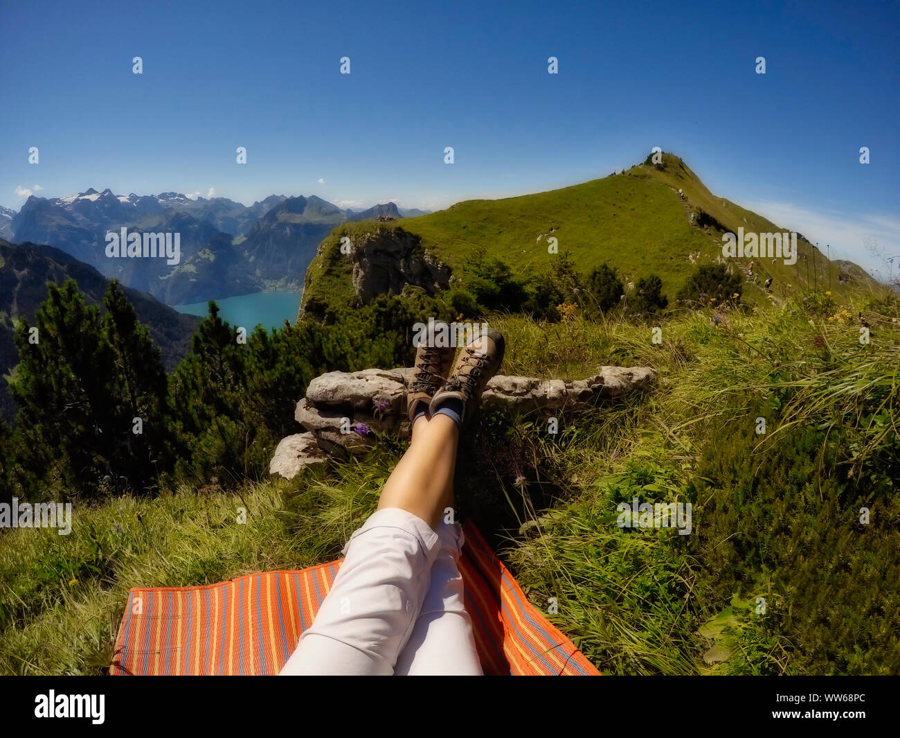 Woman's legs lying on a blanket in the mountains, Switzerland Stock Photo