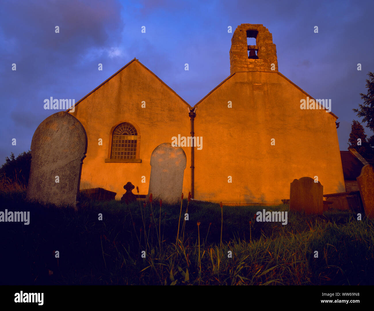 West end of Llangyhafal doubled-naved C14th church, North Wales, UK, at sunset. On raised ground between two steep lanes on W side of the Clwydians. Stock Photo
