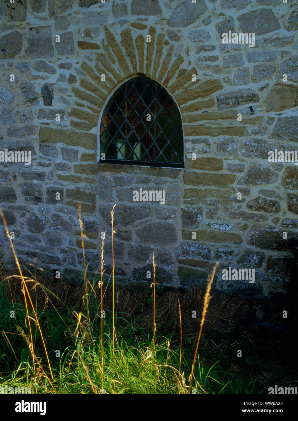 The blocked north door of Gwaenysgor church, Flintshire, Wales, UK, with a leaded window inserted to light the new vestry during the 1931 restorations Stock Photo