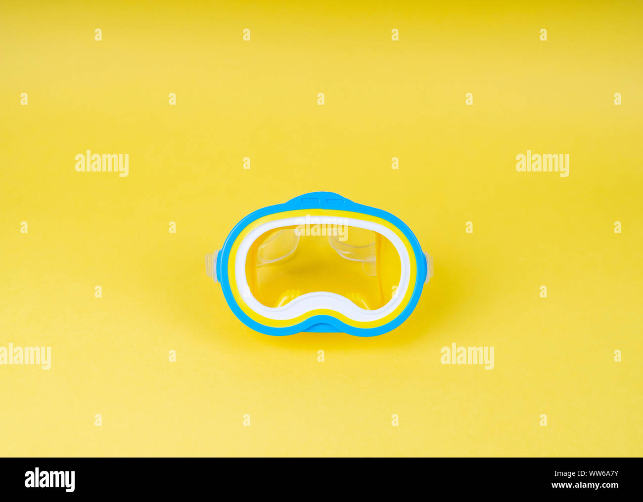 Close-up of a diving mask on yellow plain background Stock Photo