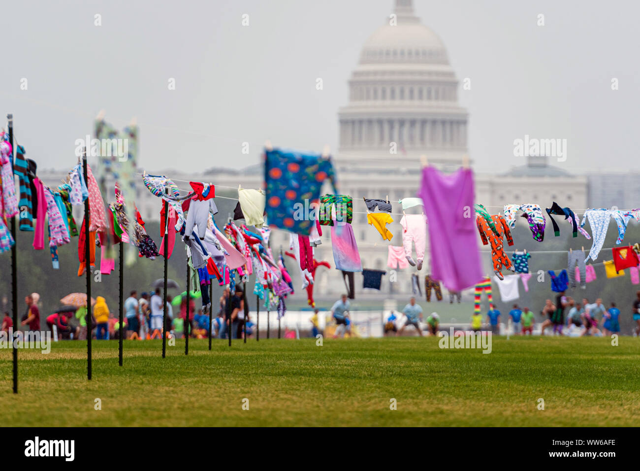 Washington DC, USA - June 9, 2019: Family Separation Protests. Symbolic washing cords with a small children's clothes next to the Capitol building. Stock Photo