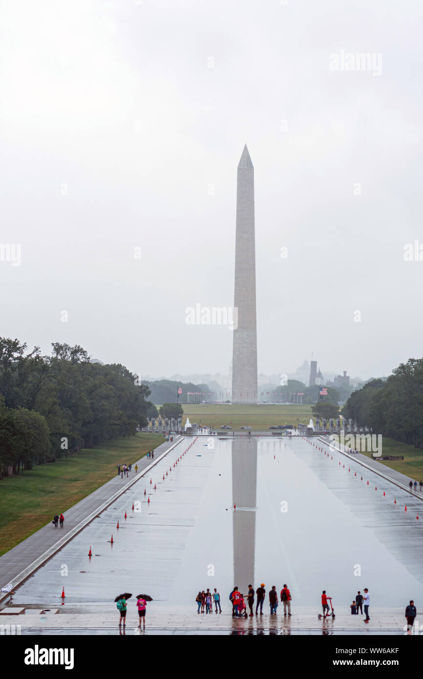 Washington DC, USA - June 9, 2019: Washington Monument on the Reflecting Pool in rainy day. Stock Photo