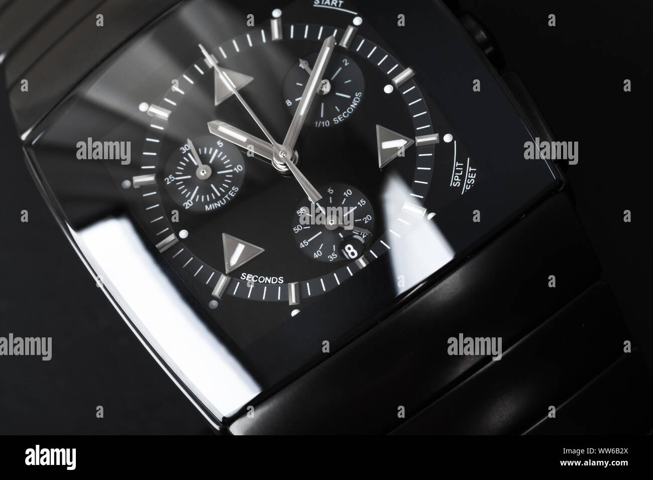 Luxury wrist watch made of black hightech ceramics. Closeup studio