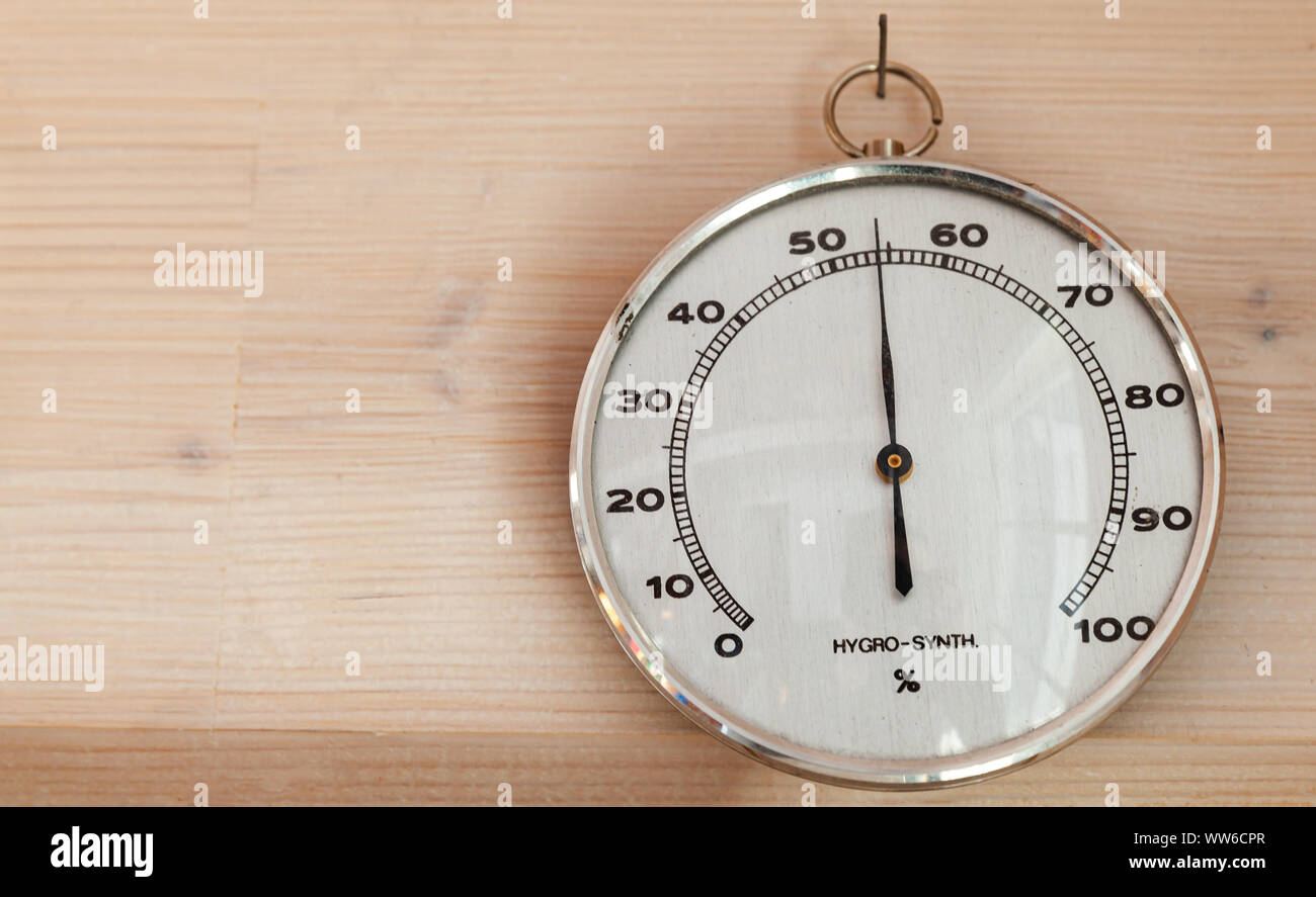 Hygrometer hanging on wooden wall, close-up photo. This instrument used to  measure the amount of humidity and water vapour in the atmosphere Stock  Photo - Alamy