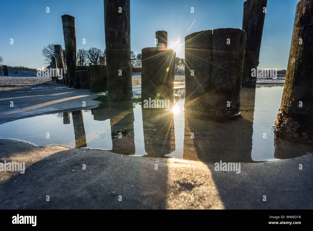 Breakwaters on the Baltic Sea at evening light, setting sun Stock Photo