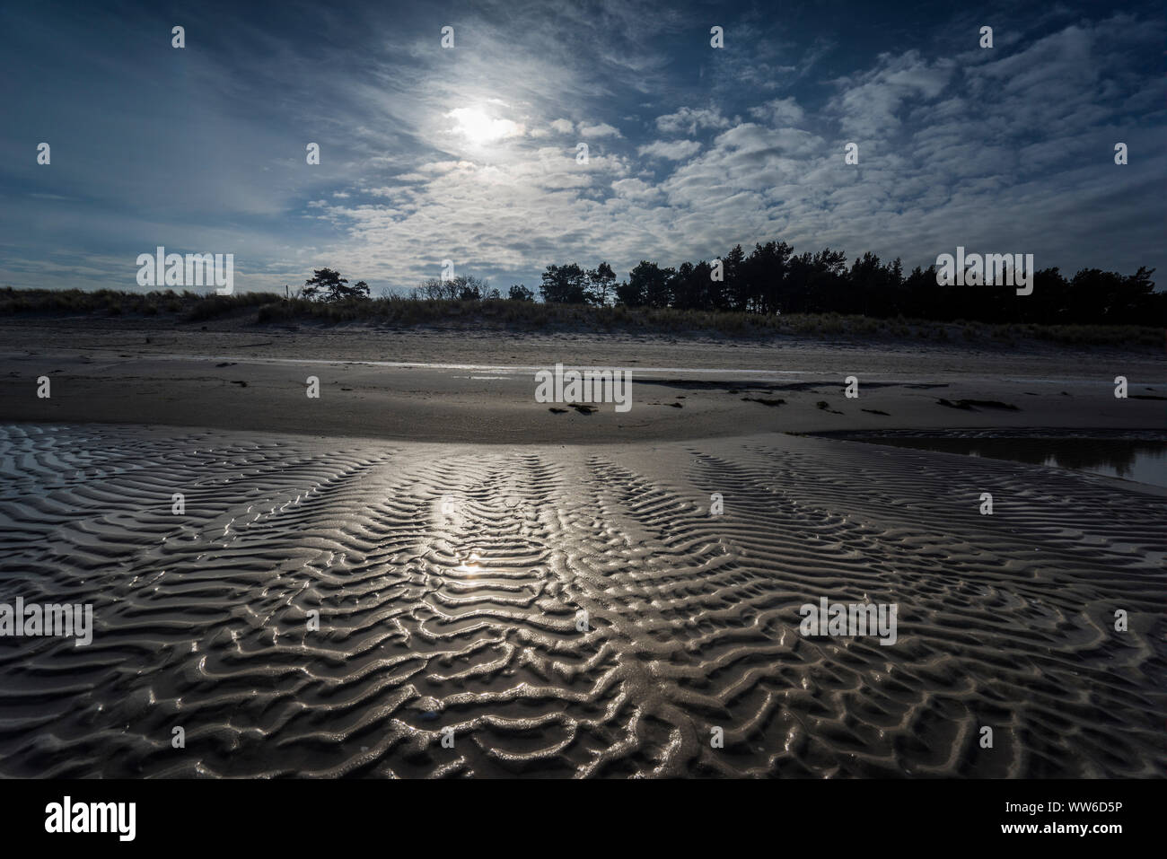 Baltic Sea at evening light and wave pattern on the beach Stock Photo