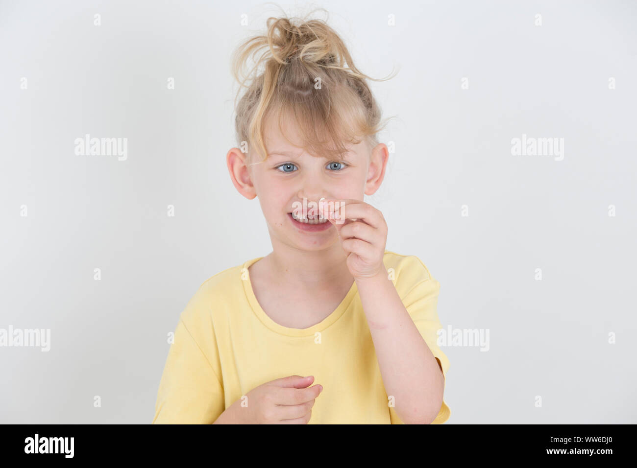 Girl with tooth in her hand, portrait Stock Photo
