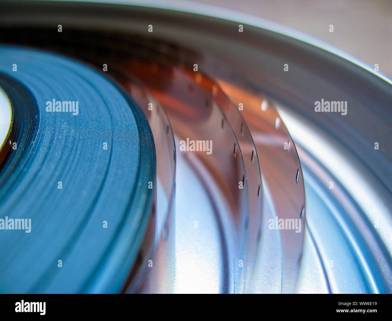 Roll of developed Super 16mm Film Negative on a Bobby in a can. 16mm Film is a popular and economical gauge of film stock. Stock Photo