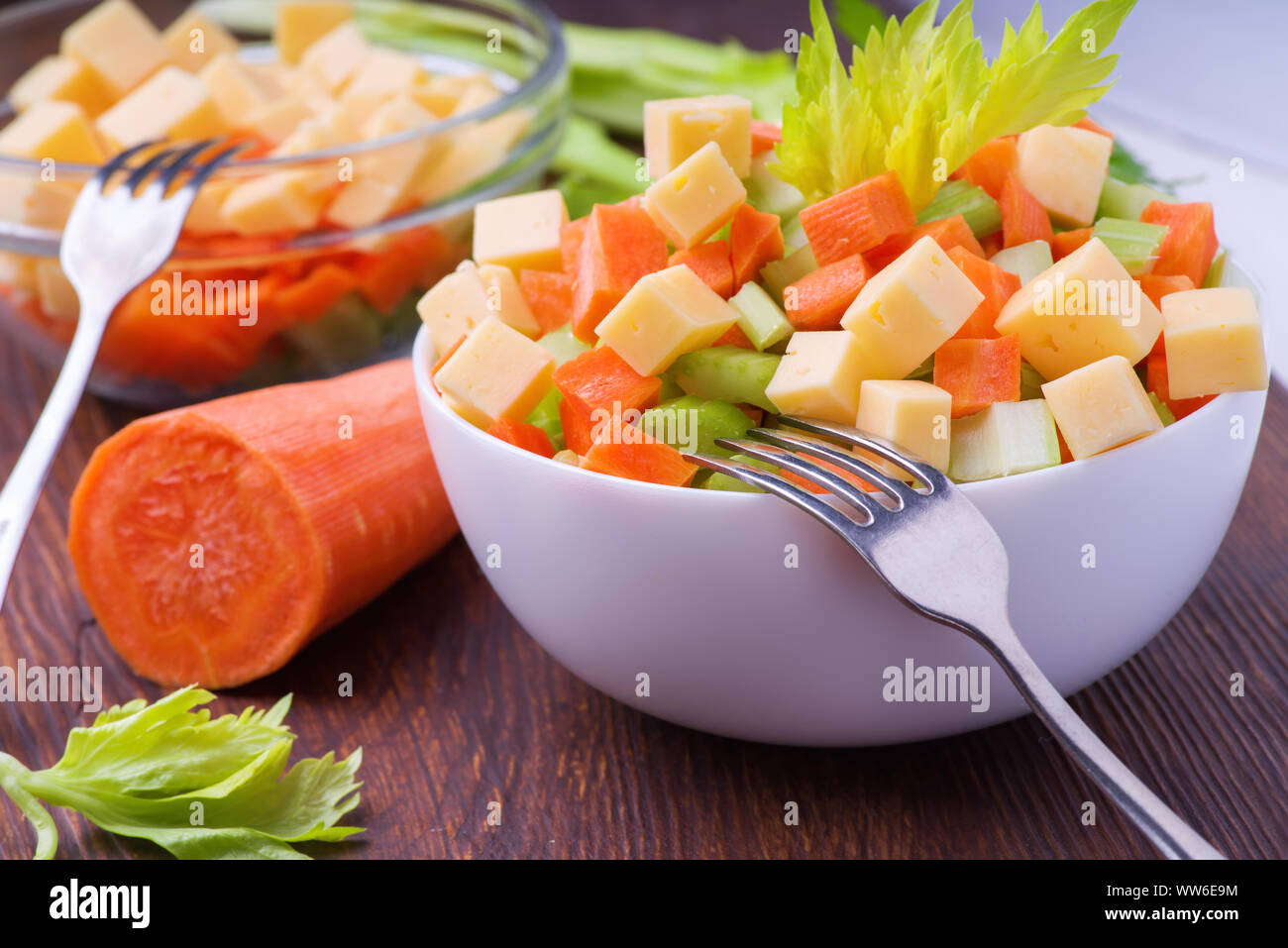 Fresh salad from stalks of celery, carrots, apples and cheese. Fitness breakfast, healthy. Stock Photo