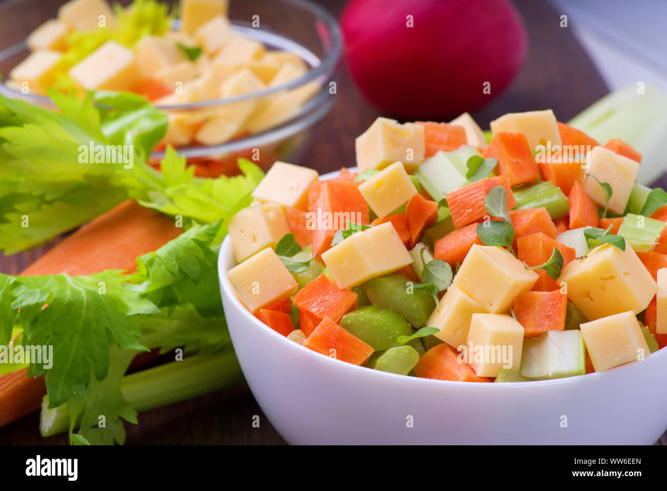 Fresh salad from stalks of celery, carrots, apples and cheese. Fitness breakfast, healthy. Stock Photo