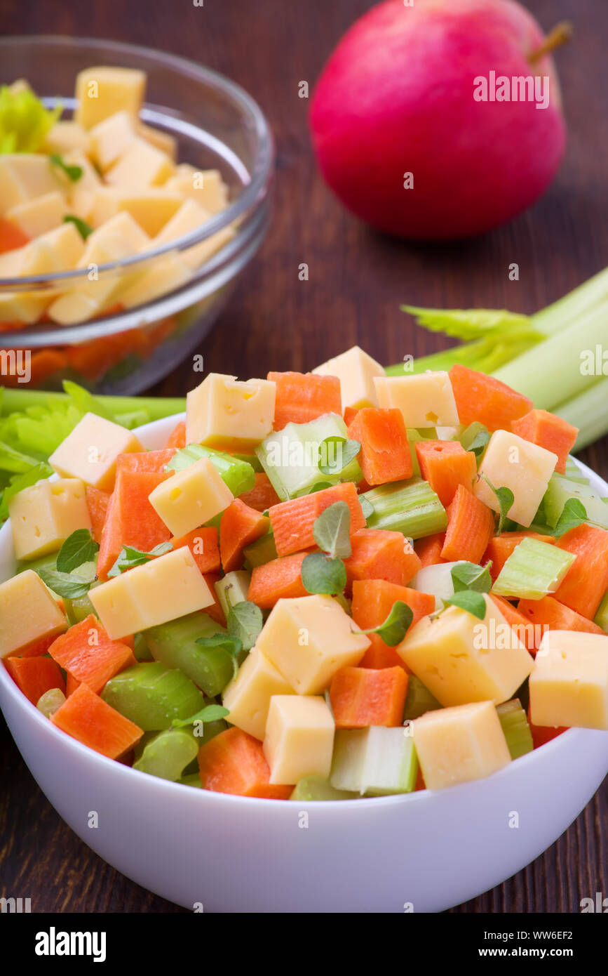 Fresh salad from stalks of celery, carrots, apples and cheese. Fitness breakfast, healthy. Stock Photo