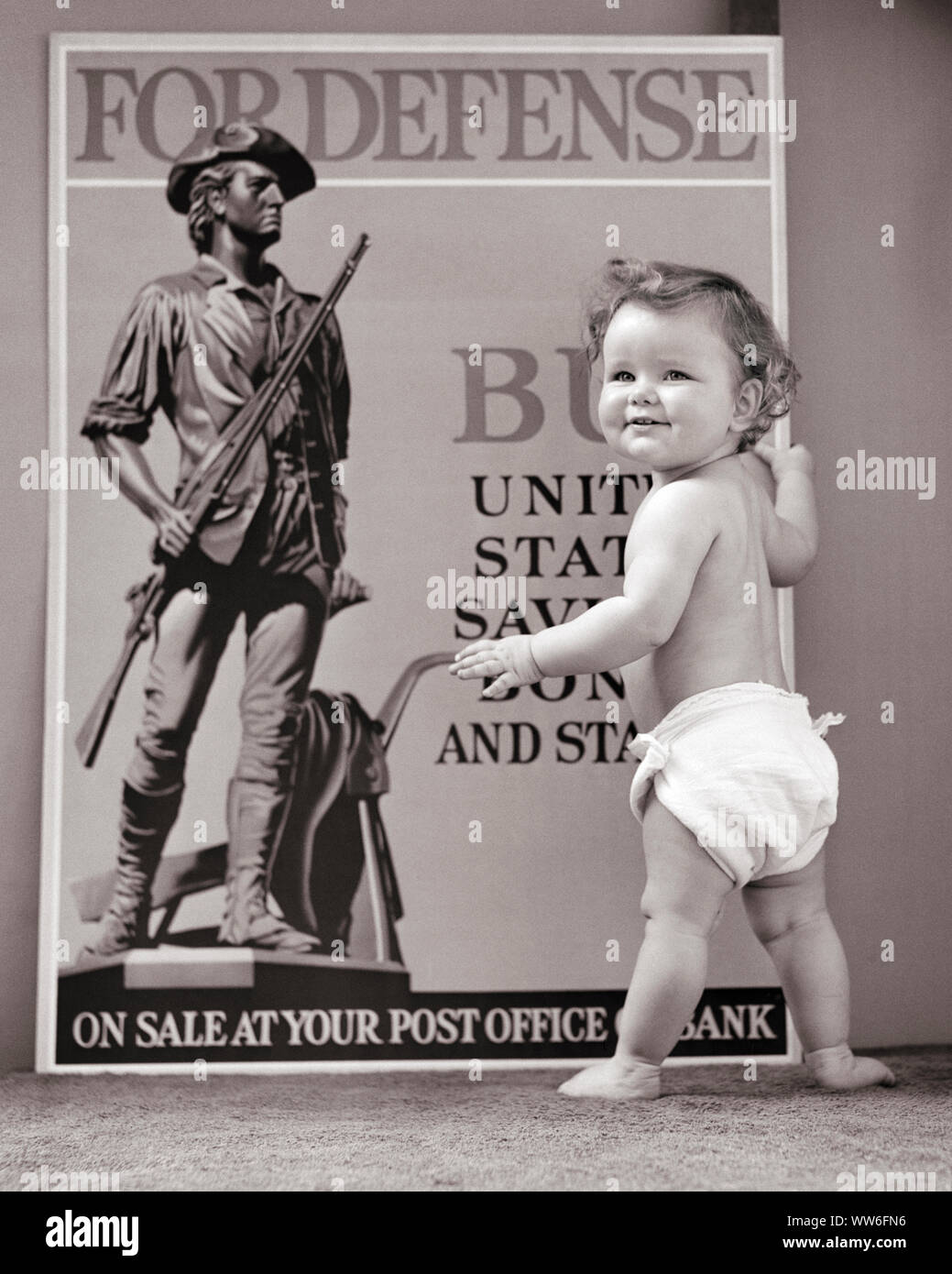 1940s TODDLER WITH MINUTE MAN DEFENSE POSTER SAVINGS BONDS WORLD WAR II - d477 HAR001 HARS DIAPER B&W NORTH AMERICA EYE CONTACT FREEDOM GOALS NORTH AMERICAN HAPPINESS BONDS PROTECTION VICTORY STRATEGY LEADERSHIP WORLD WARS PRIDE WORLD WAR WORLD WAR TWO WORLD WAR II DIAPERS PATRIOT POLITICS CONNECTION CONCEPTUAL PATRIOTIC WORLD WAR 2 DEFENSE GROWTH JUVENILES PATRIOTISM BABY GIRL BLACK AND WHITE CAUCASIAN ETHNICITY HAR001 MINUTE OLD FASHIONED Stock Photo