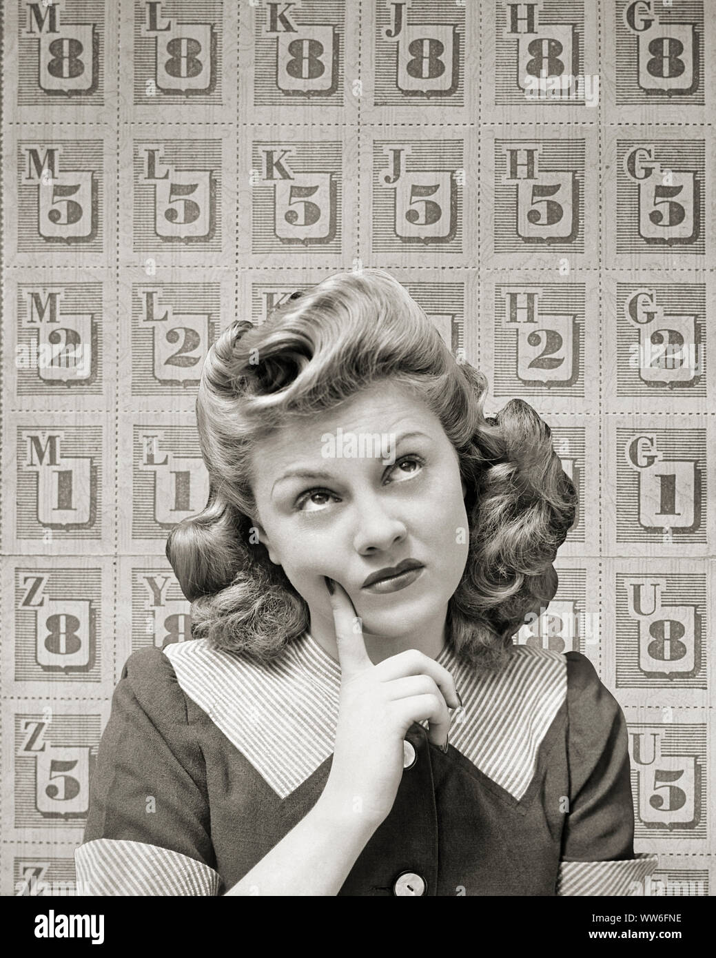 1940s WONDERING THINKING WOMAN LOOKING UP WITH RATION STAMPS IN BACKGROUND WORLD WAR II - d4863 HAR001 HARS FOODS B&W PUZZLED GOALS HOMEMAKER HOMEMAKERS HOME FRONT PROTECTION STRATEGY CHOICE WORLD WARS WORLD WAR WORLD WAR TWO WORLD WAR II UP AUTHORITY HOUSEWIVES STAMPS WAR EFFORT 1943 RATION VICTORY ROLLS RATIONING STYLISH SUPPORT WORLD WAR 2 COOPERATION LOOKING UP WONDERING YOUNG ADULT WOMAN BLACK AND WHITE CAUCASIAN ETHNICITY HAR001 OLD FASHIONED Stock Photo