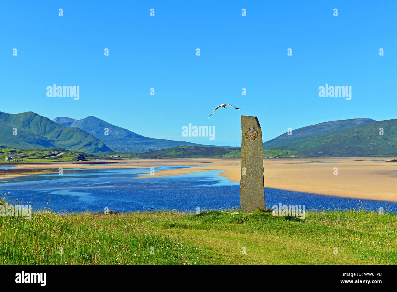 Beautiful landscape in Scottish Highlands, part of North Coast 500 route, near Durness with Celtic standing stone, water, sand, mountains and sky Stock Photo