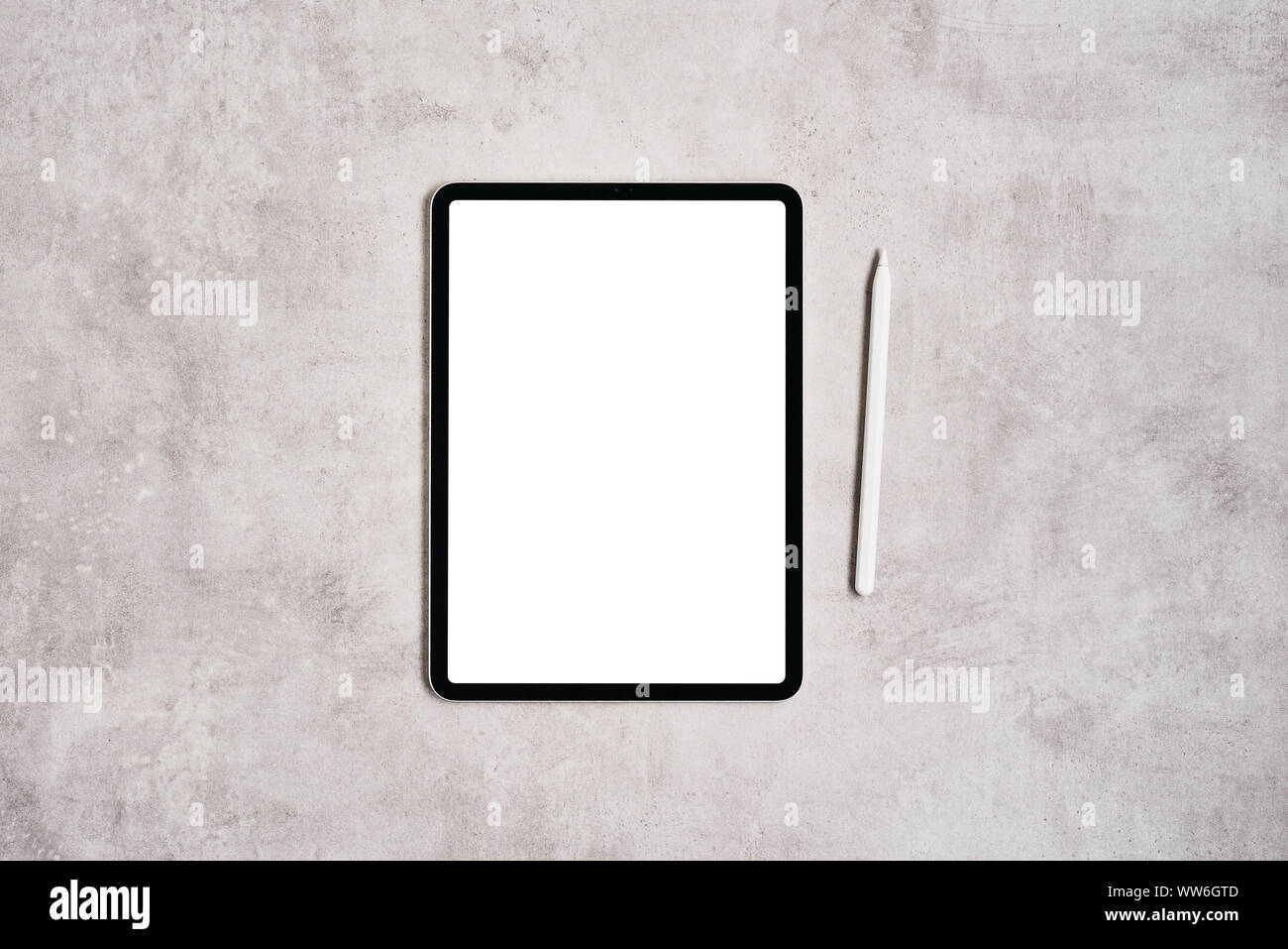 Black digital tablet with blank screen and pencil on grey concrete table. Flat lay. Copy space for text. Stock Photo