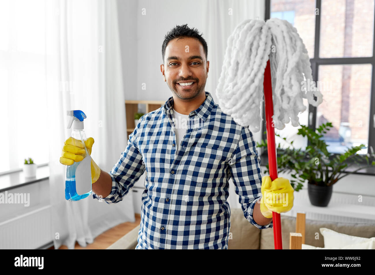 indian man with mop and detergent cleaning at home Stock Photo Alamy