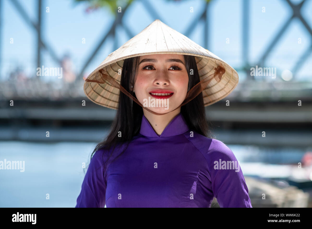 Portrait of a beautiful woman wearing traditional clothing and conical hat, Vietnam Stock Photo