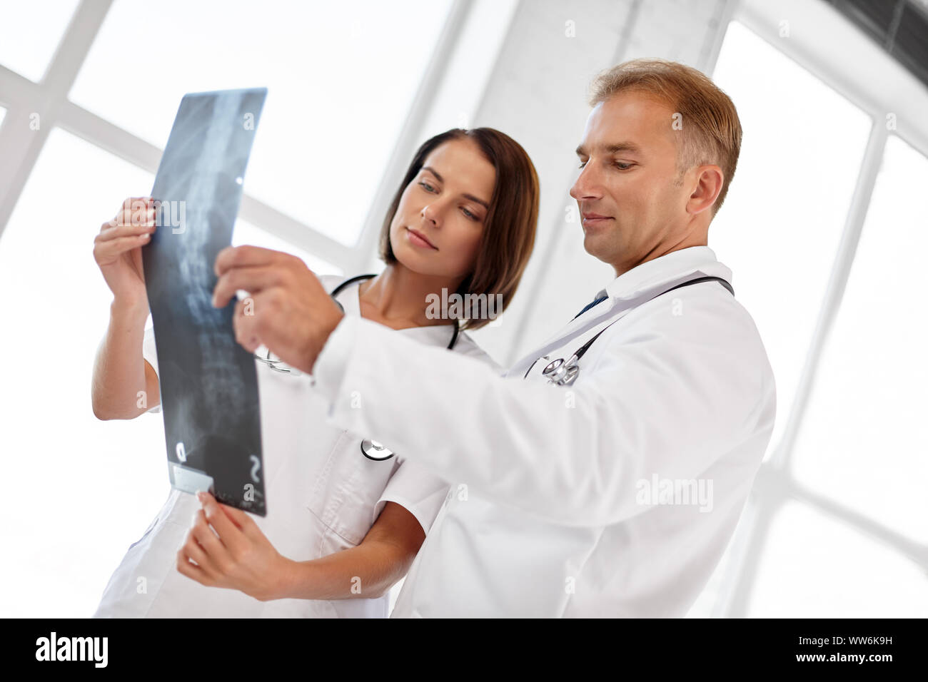 doctors with x-ray of spine at hospital Stock Photo