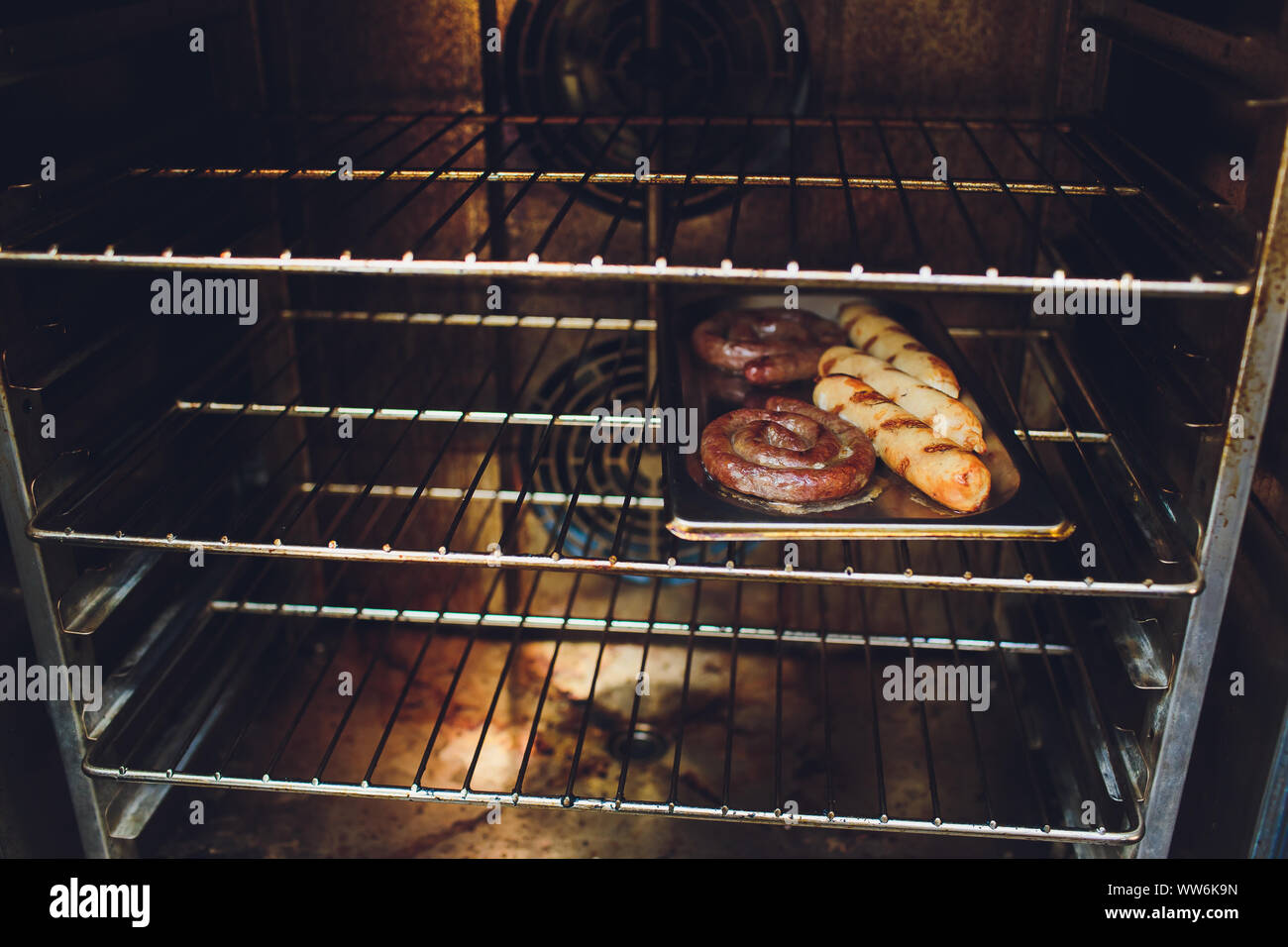 Cooking sausages in the oven. Fast food street. Fried sausages Stock Photo Alamy
