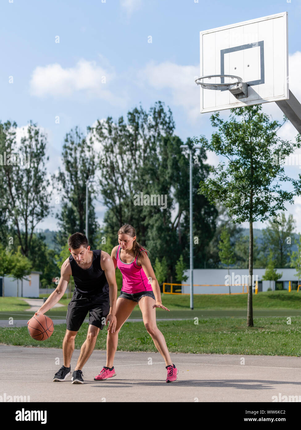 Young couple is playing basketball Stock Photo
